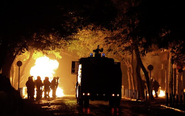 A police water cannon operates as riot police try to avoid petrol bombs during a protest in the Athens neighborhood of Exarchia, with a reputation of being a haven for extreme leftists and anarchists, on Saturday, Dec. 6, 2014 - Sputnik International