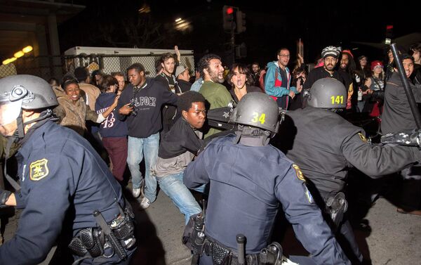 Police officers scuffle with protesters during a protest against police violence in the U.S., in Berkeley, California. More than five police vehicles suffered damage as several hundred protesters took to the streets before being dispersed with teargas. - Sputnik International