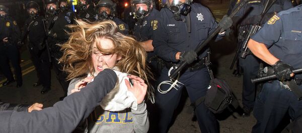A protester flees as police officers try to disperse a crowd comprised largely of student demonstrators during a protest against police violence in the U.S., in Berkeley, California early December 7, 2014 A protester flees as police officers try to disperse a crowd comprised largely of student demonstrators during a protest against police violence in the U.S., in Berkeley, California early December 7, 2014 - Sputnik International