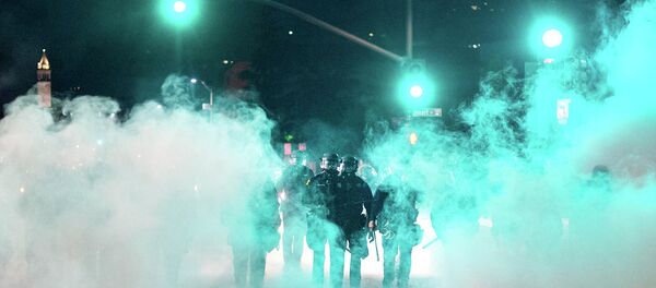 Police officers deploy teargas while trying to disperse a crowd comprised largely of student protesters during a protest against police violence in the U.S., in Berkeley, California early December 7, 2014 Police officers deploy teargas while trying to disperse a crowd comprised largely of student protesters during a protest against police violence in the U.S., in Berkeley, California early December 7, 2014 - Sputnik International