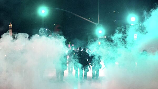 Police officers deploy teargas while trying to disperse a crowd comprised largely of student protesters during a protest against police violence in the U.S., in Berkeley, California early December 7, 2014 - Sputnik International
