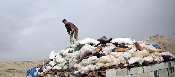 An Afghan man prepares to set opium and narcotics on fire during a drug burning ceremony on the outskirts of Kabul, Afghanistan, Wednesday, Oct. 29, 2014 An Afghan man prepares to set opium and narcotics on fire during a drug burning ceremony on the outskirts of Kabul, Afghanistan, Wednesday, Oct. 29, 2014 - Sputnik International