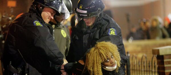 Police officers take a protester into custody Tuesday, Nov. 25, 2014, in Ferguson - Sputnik International