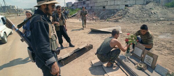 Chechen militants and Russian soldiers near graves of the fallen Chechen militants and Russian soldiers near graves of the fallen - Sputnik International