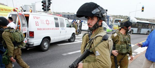 Israeli soldier stand at the scene where a Palestinian attacked civilians with a chemical substance - Sputnik International