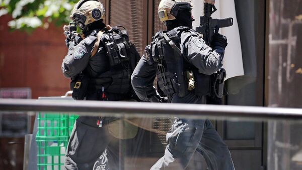 A police officer runs across Martin Place near Lindt cafe, where hostages are being held, in central Sydney December 15, 2014 - Sputnik International