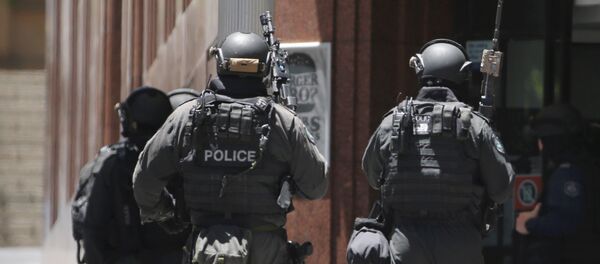 Armed police stand at the ready close to a cafe under siege at Martin Place in the central business district of Sydney, Australia, Monday, Dec. 15, 2014 Armed police stand at the ready close to a cafe under siege at Martin Place in the central business district of Sydney, Australia, Monday, Dec. 15, 2014 - Sputnik International
