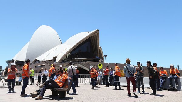 Construction workers gather in front of the Sydney Opera House after being evacuated - Sputnik International