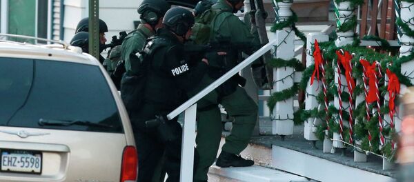 Police gather near a home, Monday, Dec. 15, 2014, in Pennsburg, Pa., where suspect Bradley William Stone is believed to have barricaded himself inside after shootings at multiple homes Police gather near a home, Monday, Dec. 15, 2014, in Pennsburg, Pa., where suspect Bradley William Stone is believed to have barricaded himself inside after shootings at multiple homes - Sputnik International