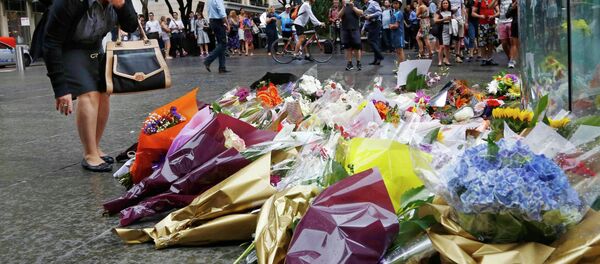 A woman reacts after placing a floral tribute for those who died in the Sydney cafe siege, near the site of the incident, in Martin Place December 16, 2014 A woman reacts after placing a floral tribute for those who died in the Sydney cafe siege, near the site of the incident, in Martin Place December 16, 2014 - Sputnik International