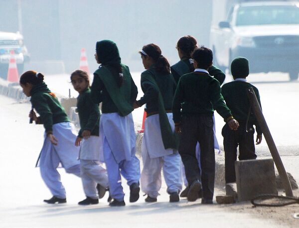 Schoolchildren cross a road as they move away from a military run school that is under attack by Taliban gunmen in Peshawar, December 16, 2014 Schoolchildren cross a road as they move away from a military run school that is under attack by Taliban gunmen in Peshawar, December 16, 2014 - Sputnik International