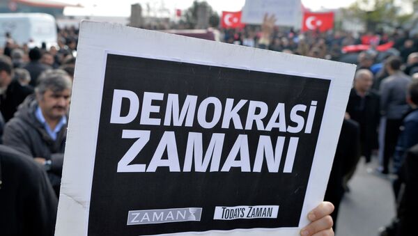 A man holds a placard that reads  a time for democracy  as people gather in support outside Zaman - Sputnik International