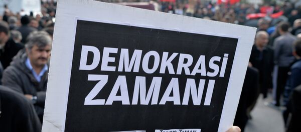 A man holds a placard that reads a time for democracy as people gather in support outside Zaman A man holds a placard that reads a time for democracy as people gather in support outside Zaman - Sputnik International