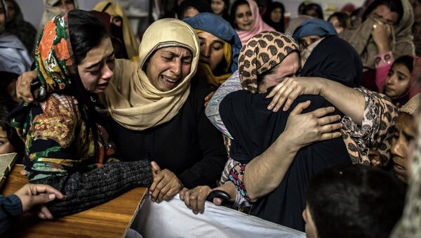 Women mourn their relative Mohammed Ali Khan, 15, a student who was killed during an attack by Taliban gunmen on the Army Public School, at his house in Peshawar December 16, 2014. - Sputnik International