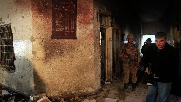 A local cameraman films in front of an army soldier at the Army Public School, which was attacked by Taliban gunmen, in Peshawar, December 17, 2014. - Sputnik International