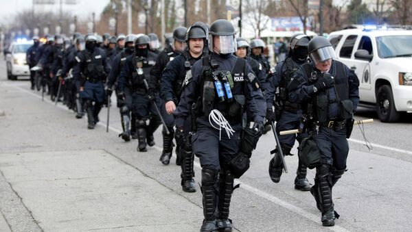 Police wearing riot gear walk past Edward Jones Dome following an NFL football game between the St. Louis Rams and the Oakland Raiders - Sputnik International