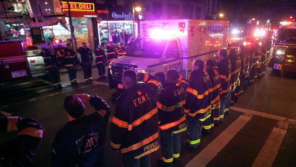 An ambulance carrying one of the two New York Police officers who were shot dead passes by a New York Fire Department honor guard along Broadway in the Brooklyn borough of New York - Sputnik International