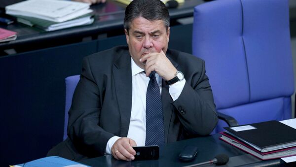 Germany's Economy Minister Sigmar Gabriel holds a MOBILE phone during a debate at the lower house of parliament Bundestag in Berlin, November 26, 2014 - Sputnik International