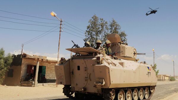 In this Tuesday, May 12, 2013 file photo, Egyptian Army soldiers patrol in an armored vehicle backed by a helicopter gunship during a sweep through villages in in Sheikh Zuweyid, northern Sinai, Egypt - Sputnik International