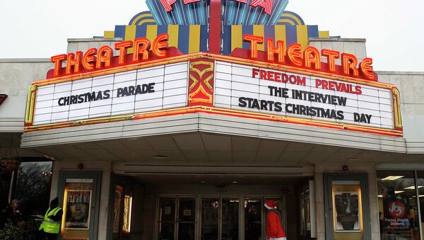 A man dressed as Santa Claus walks under the marquee at the Plaza Theatre that will be showing the movie The Interview beginning Christmas Day in Atlanta, Georgia December 23, 2014 - Sputnik International