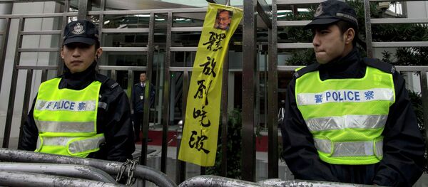 Pro-democracy protesters hold signs and posters of jailed Chinese Nobel Peace Prize laureate Liu Xiaobo (R) and his wife Liu Xia (C) during a protest outside the Chinese liaison office in Hong Kong - Sputnik International