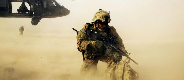 A U.S. soldier from the 3rd Cavalry Regiment shields himself from the rotor wash of a UH-60 Blackhawk helicopter after being dropped off for a mission with the Afghan police near Jalalabad A U.S. soldier from the 3rd Cavalry Regiment shields himself from the rotor wash of a UH-60 Blackhawk helicopter after being dropped off for a mission with the Afghan police near Jalalabad - Sputnik International
