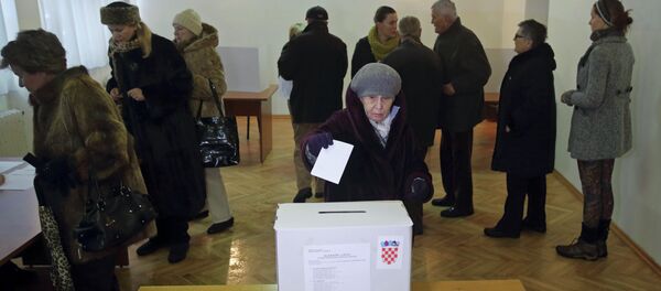 A woman casts her ballot at a polling station during the presidential election in Zagreb A woman casts her ballot at a polling station during the presidential election in Zagreb - Sputnik International