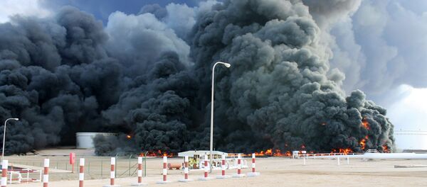 Smoke rises from an oil tank fire in Es Sider port Smoke rises from an oil tank fire in Es Sider port - Sputnik International
