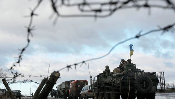 A Ukrainian military convoy is pictured through a barbed wire fence at a military base in the town of Kramatorsk, eastern Ukraine - Sputnik International