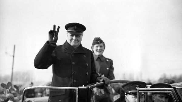 Winston Churchill holds up two fingers to make a V-sign for Victory as he salutes from an open car in Antwerp, Belgium, on Nov. 17, 1945 - Sputnik International