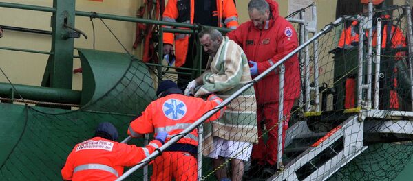 A wounded passenger is helped as he leaves from the  Spirit of Piraeus  cargo container ship after the car ferry Norman Atlantic caught fire in waters off Greece - Sputnik International