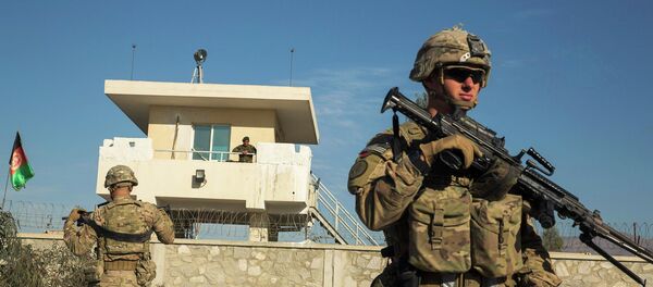 A US soldier from Dragon Company of the 3rd Cavalry Regiment stands in front of an Afghan National Army guard post during a mission near forward operating base Gamberi in the Laghman province of Afghanistan, December 28, 2014 - Sputnik International
