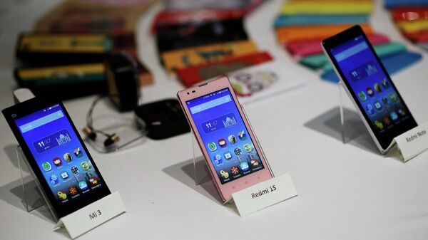 Three models of China's Xiaomi Mi phones are pictured at their launch in New Delhi 15 July 2014: File photo. - Sputnik International