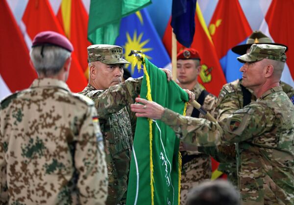 U.S. General John Campbell (C) folds the flag of the ISAF during the change of mission ceremony in Kabul, December 28, 2014 U.S. General John Campbell (C) folds the flag of the ISAF during the change of mission ceremony in Kabul, December 28, 2014 - Sputnik International