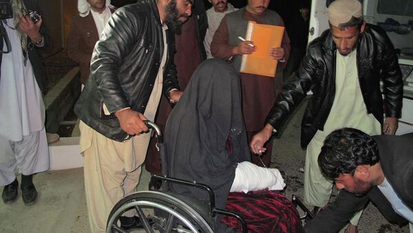 A wounded Afghan woman  is brought to the hospital in Helmand province early on January 1, 2015 - Sputnik International