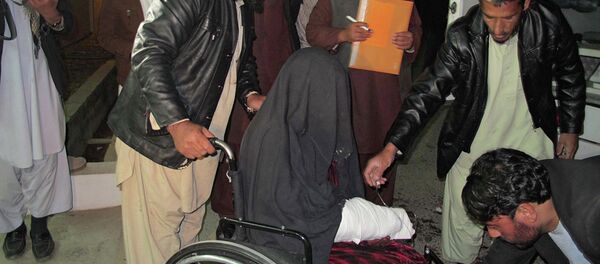 A wounded Afghan woman  is brought to the hospital in Helmand province early on January 1, 2015 - Sputnik International