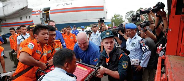 A Russian search and rescue team loads their equipment after arriving on a Beriev Be-200 amphibious plane to support the search for Indonesia AirAsia flight QZ8501, at the airport in Pangkalan Bun, Central Kalimantan A Russian search and rescue team loads their equipment after arriving on a Beriev Be-200 amphibious plane to support the search for Indonesia AirAsia flight QZ8501, at the airport in Pangkalan Bun, Central Kalimantan - Sputnik International