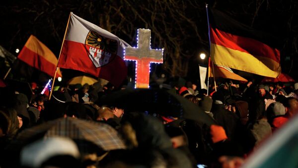 Participants take part in a demonstration called by anti-immigration group PEGIDA - Sputnik International