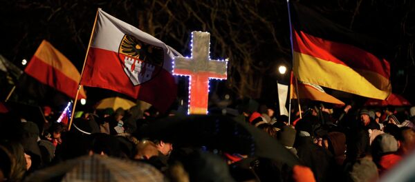 Participants take part in a demonstration called by anti-immigration group PEGIDA, a German abbreviation for Patriotic Europeans against the Islamization of the West, in Dresden January 5, 2015. Several thousand opponents of Germany's policy towards asylum seekers and Islam are expected to attend the protest in the eastern German town on Monday. Participants take part in a demonstration called by anti-immigration group PEGIDA, a German abbreviation for Patriotic Europeans against the Islamization of the West, in Dresden January 5, 2015. Several thousand opponents of Germany's policy towards asylum seekers and Islam are expected to attend the protest in the eastern German town on Monday. - Sputnik International