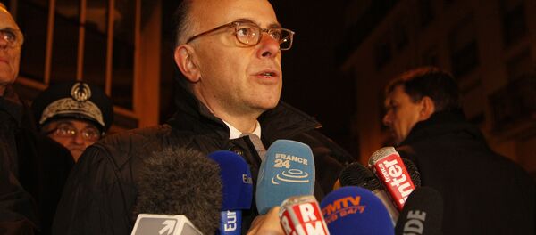 French Interior Minister Bernard Cazeneuve speaks to journalists, near the offices of the satirical weekly Charlie Hebdo, on January 7, 2015 - Sputnik International