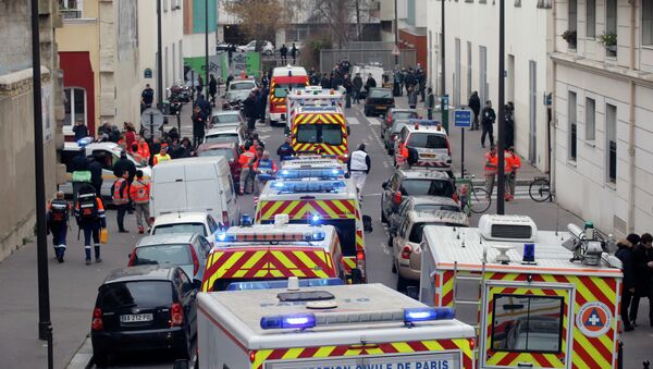 Ambulances gather in the street outside the French satirical newspaper Charlie Hebdo's office, in Paris, Wednesday, Jan. 7, 2015 - Sputnik International