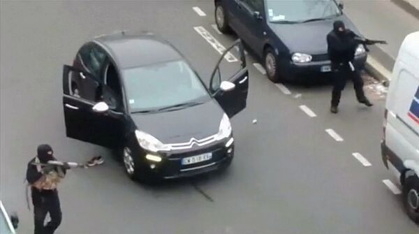 Gunmen flee the offices of French satirical newspaper Charlie Hebdo in Paris, in this still image taken from amateur video shot on January 7, 2015, and obtained by Reuters Gunmen flee the offices of French satirical newspaper Charlie Hebdo in Paris, in this still image taken from amateur video shot on January 7, 2015, and obtained by Reuters - Sputnik International