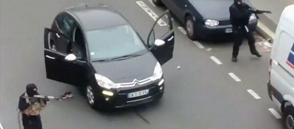 Gunmen flee the offices of French satirical newspaper Charlie Hebdo in Paris, in this still image taken from amateur video shot on January 7, 2015, and obtained by Reuters - Sputnik International