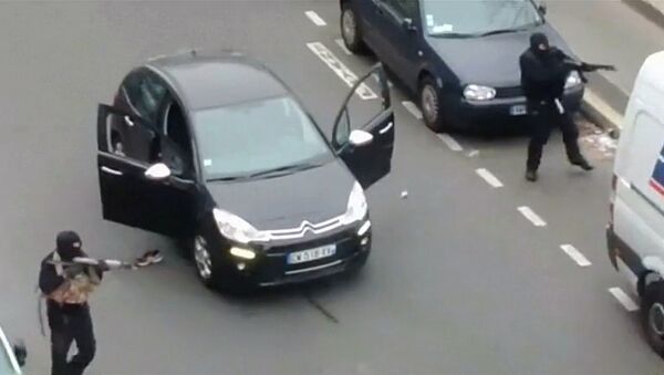 Gunmen flee the offices of French satirical newspaper Charlie Hebdo in Paris, in this still image taken from amateur video shot on January 7, 2015, and obtained by Reuters - Sputnik International