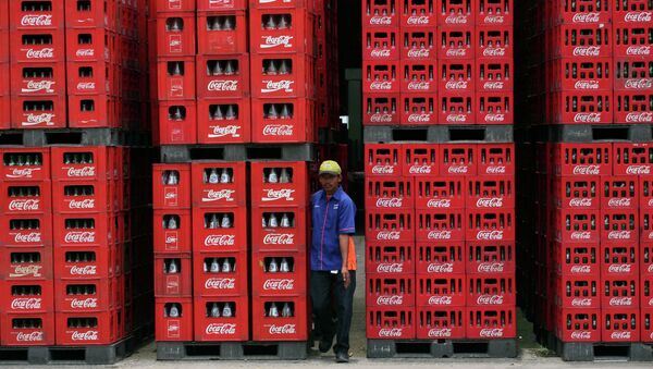 A worker walks through bottles at Coca Cola plant in Cibitung , West Java, Indonesia, Thursday, Feb. 24, 2011 - Sputnik International