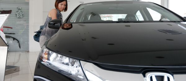 In this Dec. 22, 2014 photo, a woman checks out a new Honda City at a Honda showroom in Petaling Jaya, Malaysia In this Dec. 22, 2014 photo, a woman checks out a new Honda City at a Honda showroom in Petaling Jaya, Malaysia - Sputnik International