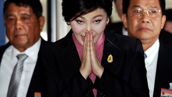Ousted former Prime Minister Yingluck Shinawatra greets in a traditional way as she arrives at Parliament before the National Legislative Assembly meeting in Bangkok January 9, 2015. - Sputnik International