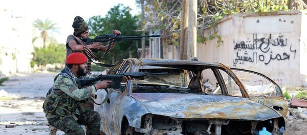 Pro-government Libyan forces, who are backed by locals, aim their weapons during clashes in the streets with the Shura Council of Libyan Revolutionaries, an alliance of former anti-Gaddafi rebels, who have joined forces with the Islamist group Ansar al-Sharia, in Benghazi Pro-government Libyan forces, who are backed by locals, aim their weapons during clashes in the streets with the Shura Council of Libyan Revolutionaries, an alliance of former anti-Gaddafi rebels, who have joined forces with the Islamist group Ansar al-Sharia, in Benghazi - Sputnik International