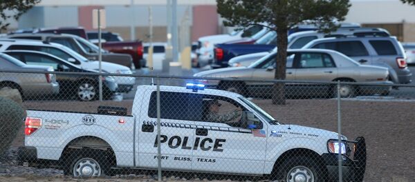 A Fort Bliss Military Police vehicle drives along the perimeter of the El Paso VA parking lot as officers searched for a gunman following a shooting inside the facility Tuesday, Jan. 6, 2014. A Fort Bliss Military Police vehicle drives along the perimeter of the El Paso VA parking lot as officers searched for a gunman following a shooting inside the facility Tuesday, Jan. 6, 2014. - Sputnik International