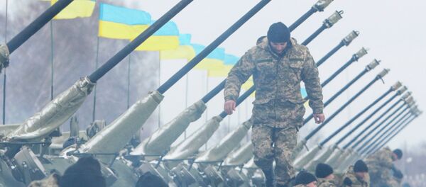 A Ukrainian serviceman walks on armoured personnel carriers (APC) A Ukrainian serviceman walks on armoured personnel carriers (APC) - Sputnik International